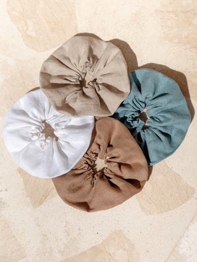 Image features Jumbo Linen Scrunchie in Tahiti Blue, Flax, Cinnamon and White.