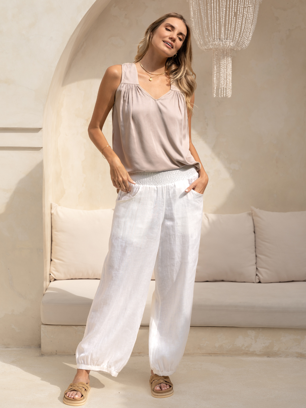 Model wears Sadhu French Linen Pants Tall in White.