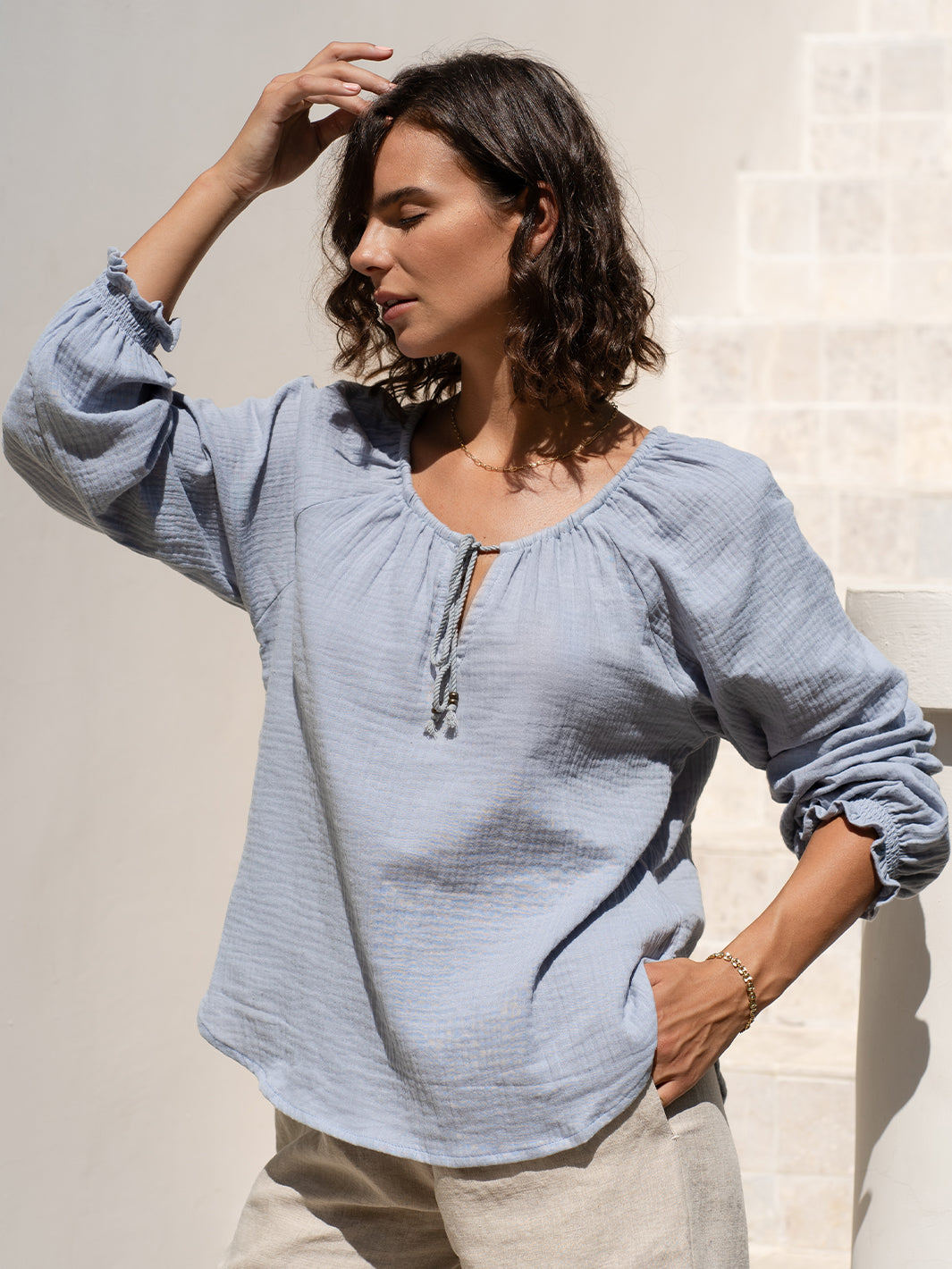 Model wears Capri Cotton Blouse in Slate Blue