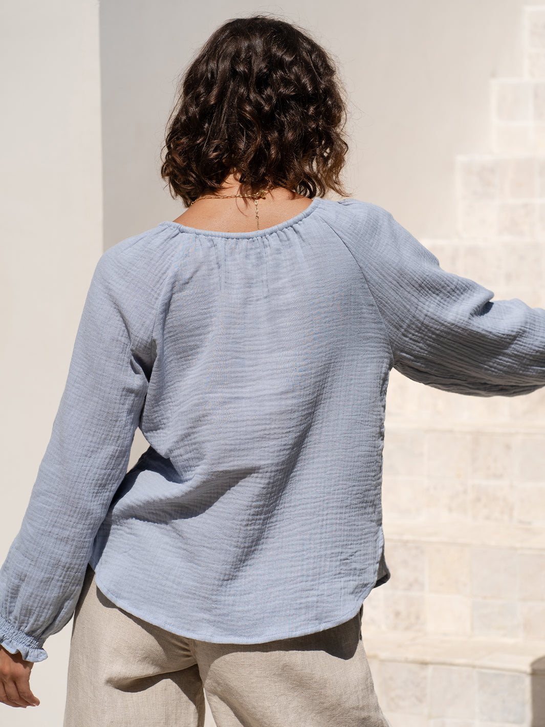 Model wears Capri Cotton Blouse in Slate Blue