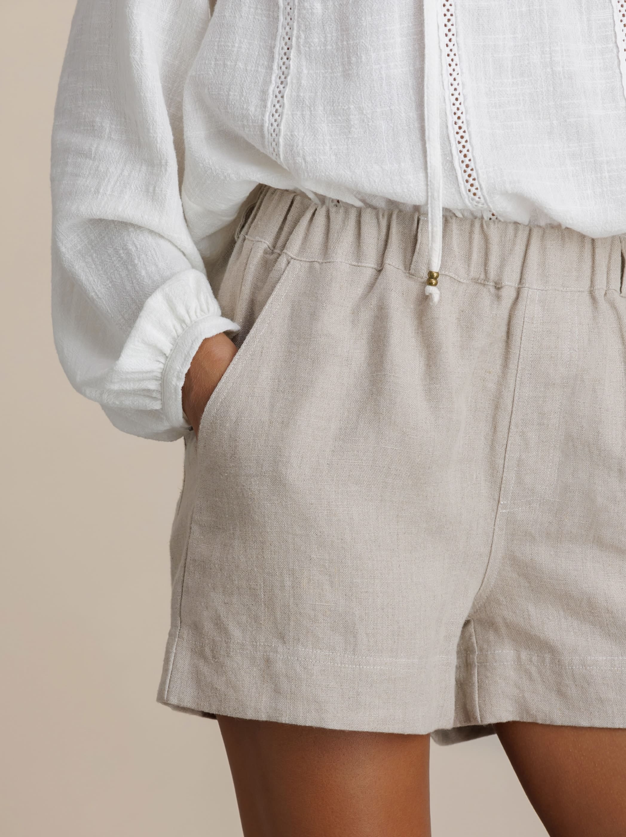 Model wears Dahlia Linen Shorts in Flax