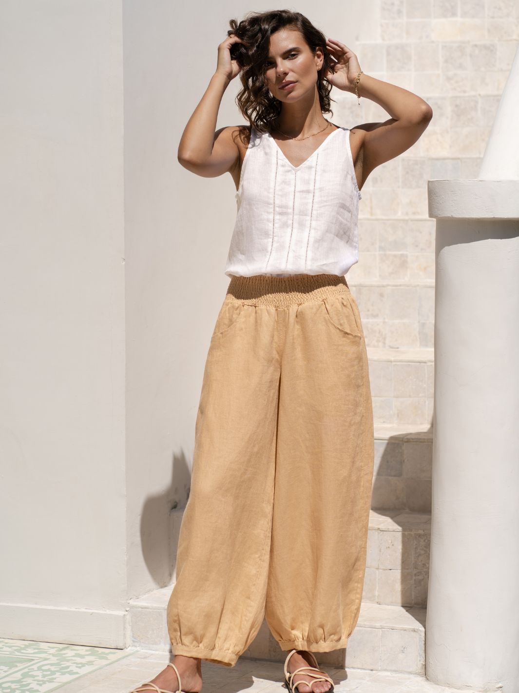 Model wears Sadhu French Linen Pants in Sand